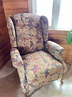 Front view of floral wingback armchair
