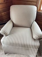 Front view of striped upholstered armchair