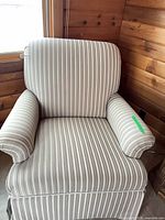 Front view of striped upholstered armchair