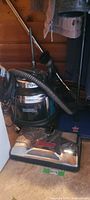 Filter Queen canister vacuum, hose, wand, and chrome power nozzle with Bissell 2650 sweeper visible