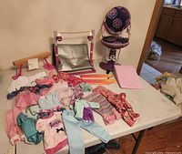 Gymnastics beam, uneven bars, salon chair, clothing spread on table