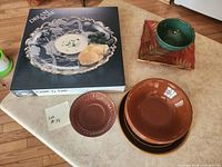 Lot overview with boxed Dream Rose set, stack of brown bowls, square plate with green bowl