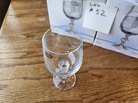 Single Claudia crystal goblet displayed in front of boxed sets