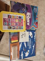 Close-up of Finding Dory book, tablet, colouring kit with pencils and ink pads
