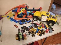 Overall lot showing vehicles and track pieces on table
