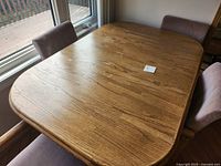 Top view of oak dining table surface and two chairs