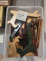 Bin with multiple gold, green marbled, and red marbled folding stands