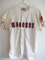 Full front view showing jersey, buttons, lettering