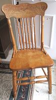 Full view of pressed back wooden chair showing overall design and condition