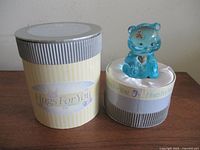 Bear figurine beside presentation box