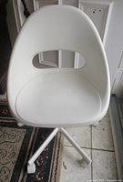 Full front view of white swivel chair on caster base