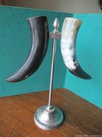 Full view of faux horn piece on silver pedestal front angle