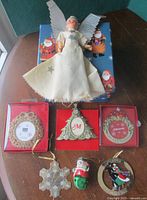 Group shot shows angel tree topper, three boxed ornaments, and three loose ornaments