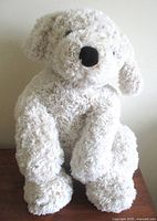 Front view of cream plush dog showing overall appearance