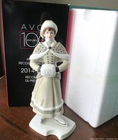 Figurine standing beside original box and styrofoam insert