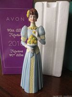 Front view of figurine with box and insert