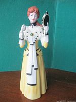 Front view of 2018 Mrs. Albee porcelain figurine holding brush and mirror