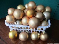 Basket filled with gold matte ornaments