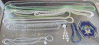 Overview of all necklaces, chains, bracelet, earrings and beadwork on tray