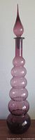 Full view of the Empoli amethyst six-gourd decanter with stopper