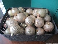Basket filled with gold glitter ornaments