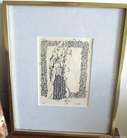 Full view of framed artwork showing gold frame and mat