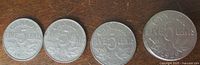 Reverse sides of four coins including visible dates 1924, 1924, 1927, 1929