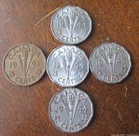 All five Victory nickels arranged on wood surface