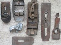 All seven metal parts laid out on carpet