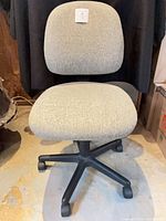 Full view of grey fabric Global office chair on black five-caster base