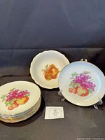 Fruit bowl and plates front view showing motif and gold rims