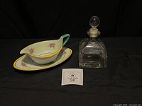 Full lot view showing gravy boat on underplate and glass decanter with stopper