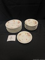 Stacked bread plates and bowls showing quantity and pattern