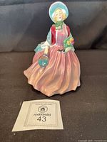 Full view of Royal Doulton Honey figurine with MaxSold lot tag