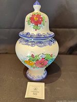 Full view of lidded urn showing shape and floral design