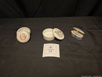 Group of three trinket boxes on black background