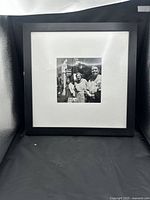 Front view of framed Vivian Maier print within black frame and white mat