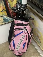 Full view of pink Beres golf bag with clubs