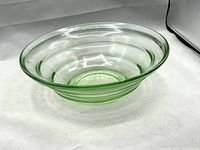 Oblique view of entire bowl showing clear-green glass and stepped ring design