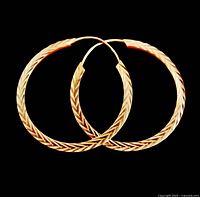 Both gold hoop earrings on black background showing chevron engraving and polished reverse