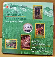 Front of cardboard outer sleeve showing coin window and wildlife images
