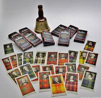 Group shot: nine card boxes, loose sample cards arranged, Wade miniature bottle centred