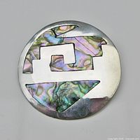 Front view showing full abalone inlay pattern and silver surface