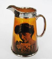 Front view showing portrait, amber glaze, silver rim