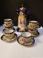Full set showing cocoa pot, six cups and saucers