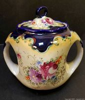 Front view showing full jar, lid, handles and floral design