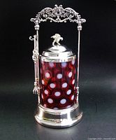 Complete assembled pickle castor set showing frame, glass insert, lid, tongs