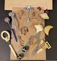 Full group of nine hat pins arranged on 1927 fashion catalogue page