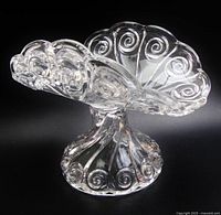 Oblique view showing scalloped U-shaped bowl and pedestal swirl design