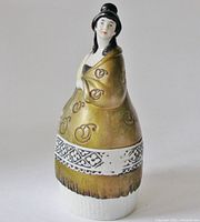Angled front view of porcelain figurine powder jar showing top and bottom pieces together